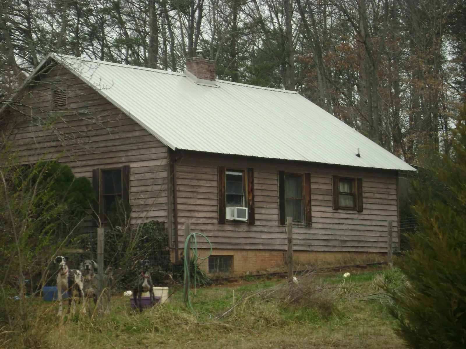 White metal roof on an old wood sided farmhouse, from a Metal Roof Installation job in Lenox